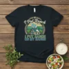 I Put Ranch ON MY RANCH t-shirt design featuring a bottle of ranch dressing pouring onto a house, with wheat