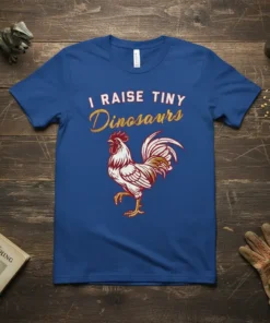 I RAISE TINY Dinosaurs text with a detailed rooster graphic on a royal blue t-shirt