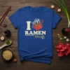 I RAMEN text design with a steaming bowl of ramen and chopsticks on a blue t-shirt