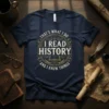 Navy t-shirt with vintage circular design: "THAT'S WHAT I DO I READ HISTORY AND I KNOW THINGS" and an open
