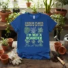Blue t-shirt with gold and green text that says "I Rescue Plants Trapped In The Store, I'm Not A Hoarder