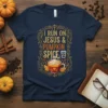 T-shirt featuring the text "I RUN ON JESUS & PUMPKIN SPICE" with a coffee cup graphic, designed for fall enthusiasts