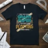 T-shirt with the quote "I See You Have Graph Paper You Must Be Plotting Something" in teal and gold typography