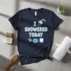 Navy t-shirt with white and light blue text reading "I Showered Today," featuring a showerhead, soap, and bubbles graphic