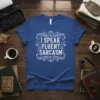 White text "I Speak Fluent Sarcasm" in a decorative frame on a royal blue t-shirt