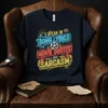 T-shirt featuring neon-style text "I Speak in Song Lyrics Movie Quotes and Sarcasm" with movie reel graphic