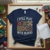 Navy t-shirt with "I Still Play With Blocks" text and colorful patchwork quilt squares design
