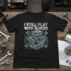 I Still Play With Blocks t-shirt design featuring a detailed V8 engine blueprint graphic and bold text