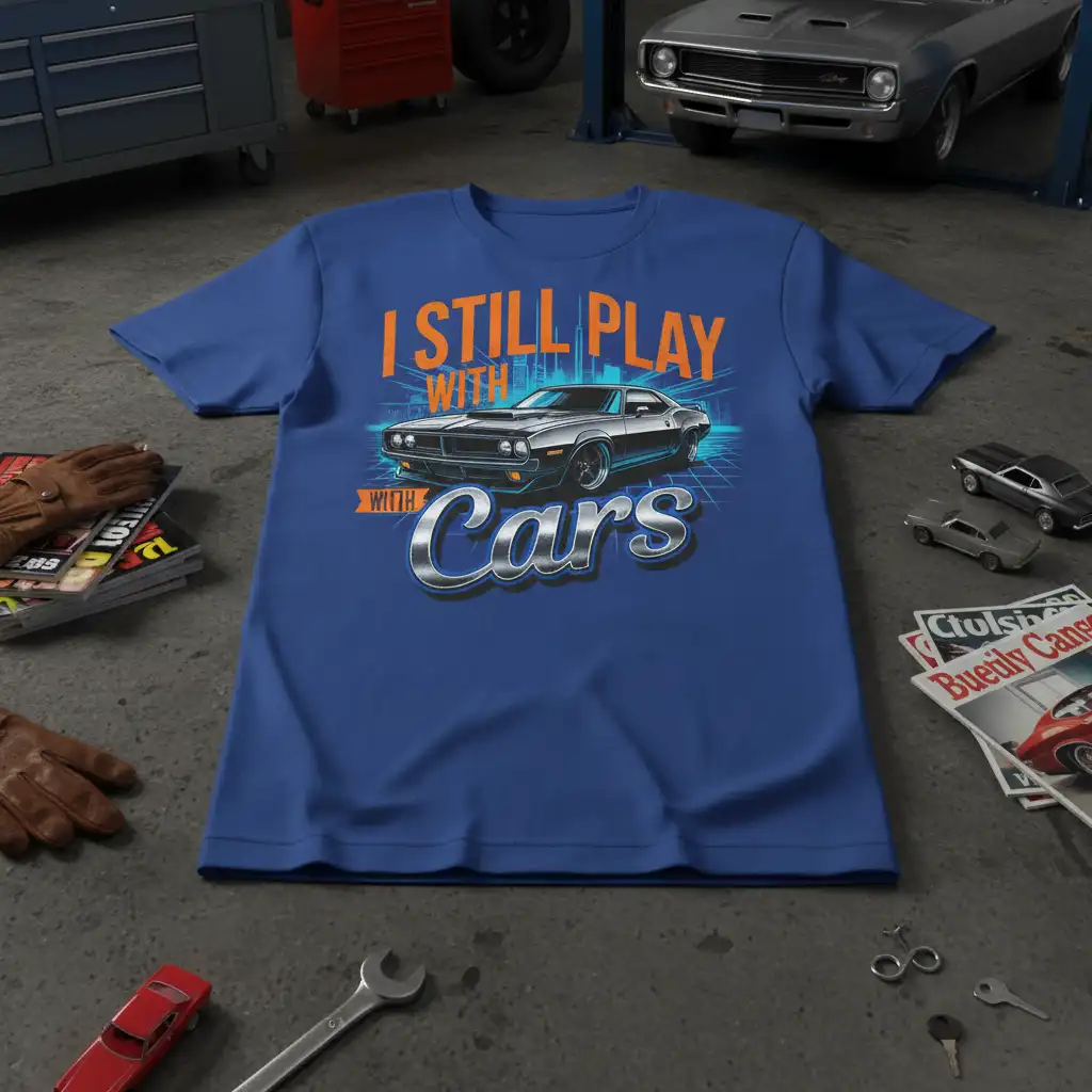 I Still Play With Cars quote with retro muscle car illustration on a vibrant blue t-shirt