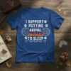 I SUPPORT PUTTING ANIMAL ABUSERS TO SLEEP text design with wolf and cat graphics on a blue t-shirt
