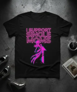 Black t-shirt with neon pink text "I SUPPORT SINGLE MOMS" and graphic of a mother holding a baby against an