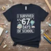 I Survived 67 Days Of School text with stacked books, globe, and winged pencil graphic on a navy t-shirt