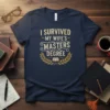 I Survived My Wife's Masters Degree text with laurel wreath and book graphic on a navy t-shirt