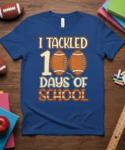 I Tackled 100 Days of School text with football graphics on a blue t-shirt, perfect for students and teachers