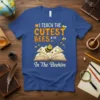Teacher t-shirt with text "I Teach The Cutest Bees In The Beehive" featuring bees and an open book graphic
