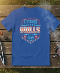 Blue t-shirt with neon-style text reading "I TURN GRILLS ON" in a shield graphic, for barbecue enthusiasts