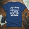 I Used To Be Married But I'm Better Now text in distressed white font on a royal blue t-shirt, celebrating