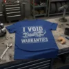 Blue t-shirt with white distressed text "I Void Warranties" above crossed wrenches graphic