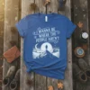 I Wanna Be Where The People Aren't quote on a blue t-shirt with a mountain landscape and moon graphic