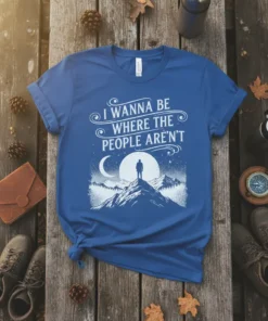 I Wanna Be Where The People Aren't quote on a blue t-shirt with a mountain landscape and moon graphic