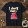 I WANT CAKE text with a pink birthday cake and candle on a navy t-shirt design