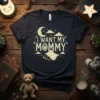"I Want My Mommy" text design with a crescent moon, ghost, clouds, and stars on a dark t-shirt