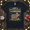 I Want A Hippopotamus For Christmas t-shirt design with a cartoon hippo wearing a Santa hat and wrapped in festive