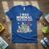 I Was Normal Two Kids Ago humorous quote on a blue t-shirt with cartoon baby items