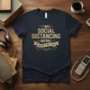 I Was Social Distancing Before It Was Cool text design on a navy t-shirt, featuring gold distressed typography and a