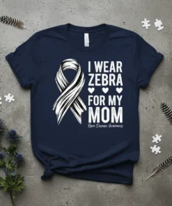 Navy blue t-shirt with white text "I Wear Zebra For My Mom" and a zebra-striped awareness ribbon. Includes "Rare Disease