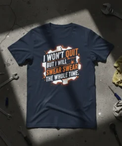 I WON'T QUIT, BUT I WILL SWEAR SWEAR THE WHOLE TIME. text design on a navy t-shirt, featuring gear graphics