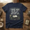 I Work Hard So My Cat Can Have A Better Life quote on a navy t-shirt with a siamese cat