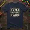 Navy t-shirt with distressed yellow text that reads "I YELL BECAUSE I CARE" in a decorative frame