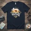 Ich Bin Ein Berliner Est. 1963 T-Shirt with a jelly donut graphic and Berlin landmarks, navy blue tee