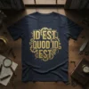 Dark navy t-shirt with gold "Id Est Quod Id Est" text surrounded by intricate steampunk gears design