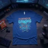 Blue t-shirt with "I'd Rather Be Gaming" text in neon orange and blue, featuring a circuit board graphic and game