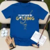Blue t-shirt with gold glitter text "I'd Rather Be Golfing" and golf club graphic