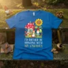 I'd Rather Be Hanging With My Gnomies text on a blue t-shirt with gnome and mushroom illustration