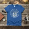 "I'd Rather Be Here Now" quote t-shirt with mountain and tree graphic, circle design, vintage style