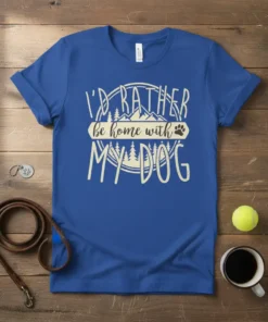 Blue t-shirt with white text that reads "I'd Rather Be Home With My Dog" featuring mountain and tree graphics