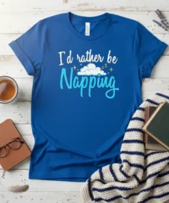 I'd Rather Be Napping quote on a blue t-shirt with cloud graphic and stars