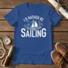I'd Rather Be Sailing t-shirt with white text and sailboat graphic on blue shirt