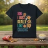 IDK I Just Really Like Snacks text with cute cartoon cookies and pretzels on a black t-shirt