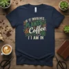 If It Involves Plants & Coffee I Am In text with coffee cup and leaf graphics on a navy t-shirt