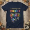 Navy t-shirt with colorful text "If nothing ever CHANGED There'd be no BUTTERFLIES" and vibrant butterfly graphics