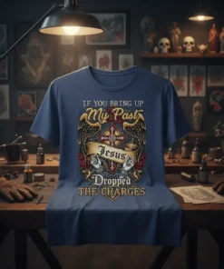 T-shirt with "IF YOU BRING UP My Past Jesus Dropped THE CHARGES" quote, featuring a cross, wings, and roses design