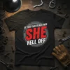 Black t-shirt with "IF YOU CAN READ THIS SHE FELL OFF" in bold red and white distressed typography, surrounded by