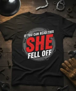 Black t-shirt with "IF YOU CAN READ THIS SHE FELL OFF" in bold red and white distressed typography, surrounded by