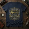 Navy t-shirt with "IF YOU DON'T LIKE MY SASSY ATTITUDE QUIT TALKING TO ME!" in ornate gold lettering and steampunk-inspired
