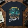 If You Feel It Chase It text with a pickup truck driving towards a tornado graphic on a navy t-shirt